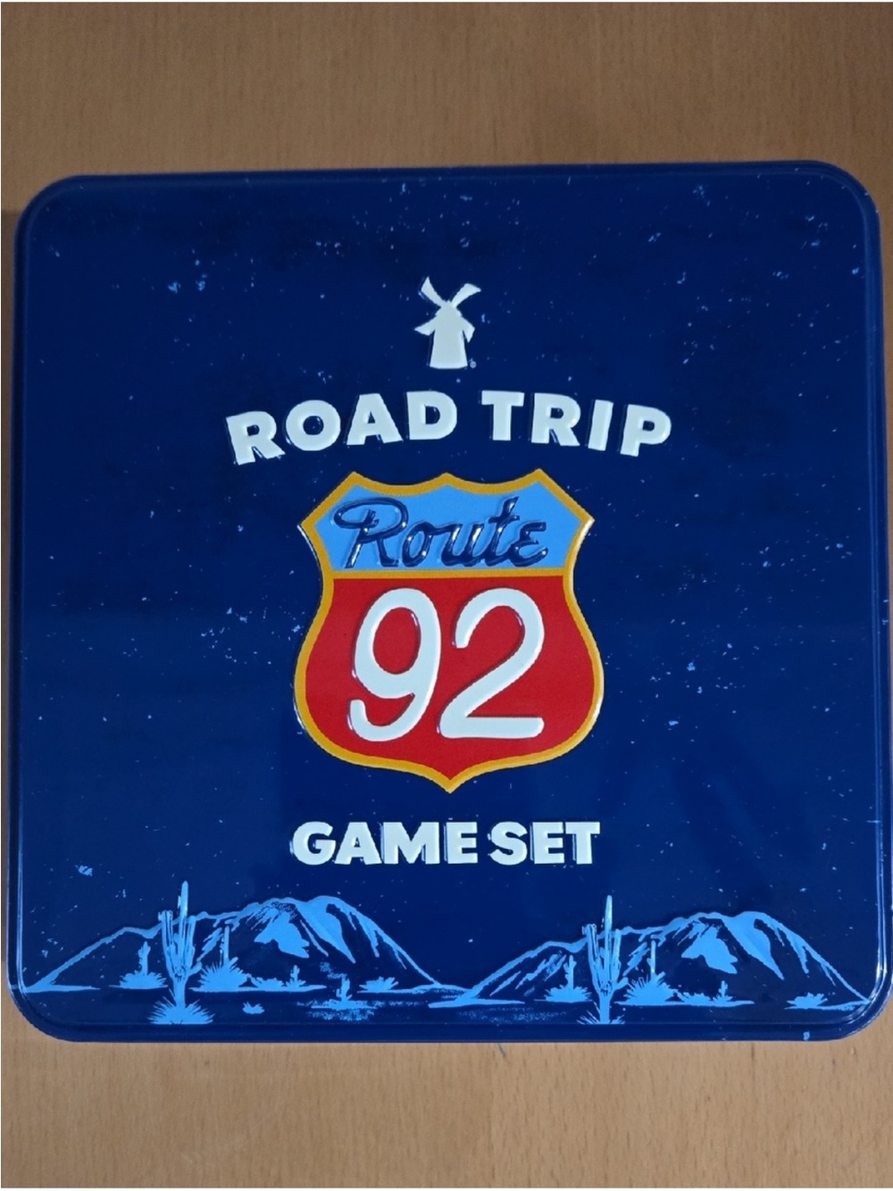 Dutch Bros Road Trip Route 92 Game Tin in Blue with Red and White Accents